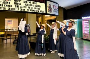 six sisters pointing to the marquis sign that has 'one battle after another'