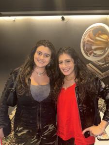 Farrah and Tamara smiling together indoors at the Recording Academy.