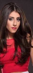 Close-up headshot of Farrah Mechael wearing a red top with long dark hair