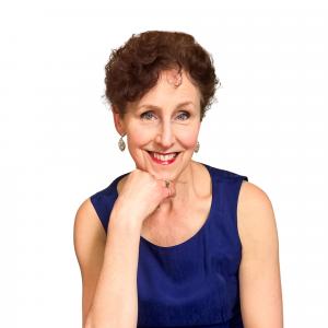 Lucy Dutton, Certified Holistic Peak Performance Coach is shown smiling.