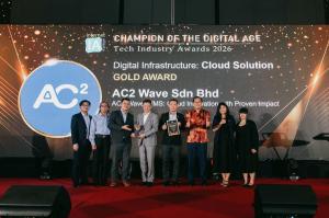 AC2 team in formal attire stands on stage, holding an award and smiling. Winning Gold Award for AC2 Wave Warehouse Management System