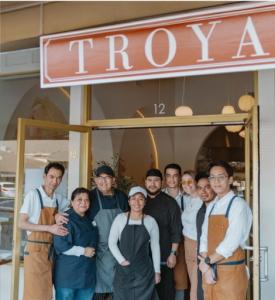 The team - owner, chef, and staff - outside the doors of Troya Mediterranean