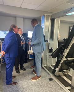 Dr. Eric Kaplan, Dr. Kevin Fogarty, and former NFL player Duane Clemons standing together at the grand opening of the DISC Centers of America / LIFE University Outpatient Clinic and Educational Center, showcasing Accu‑SPINA® and Accu‑KNEE® systems from No