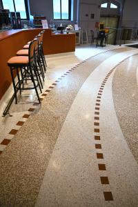 lines of squares in terrazzo leading through the space