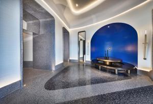 Terrazzo in different tones of gray on the floor and a matching door surround in luxury residential highrise lobby