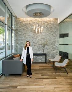 Austin dentist Dr. Negar Eslami in the modern, welcoming lobby of Downtown Dental Design