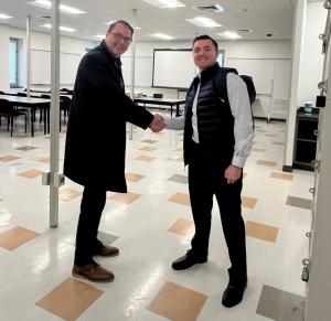 Mike Corradino and USI @ HACC Program Manager, John Easter,  Shake Hands inside a classroom at HACC's Harrisburg Campus