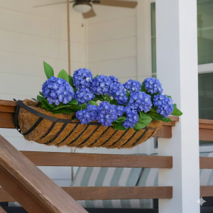 Celestial At Home's Premium Lifelike Outdoor, UV-Resistant, Waterproof Blue Hydrangea Windowbox Filler in a traditional windowbox with coco liner