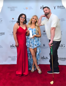 InStyler CEO Dan Fugardi and Fairiche CEO Vicki Nguyen stand on either side of upcoming singer, Brooklyn Dylan who is holding a bottle of the new Fairiche Nourishing Cream while Dan Fugardi leans on a Lucky Golf 2nd gen Gold Club.