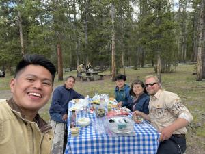 Teton Excursions owner Aaron Bailey and guests enjoying a private picnic lunch inside Yellowstone National Park on a guided tour.
