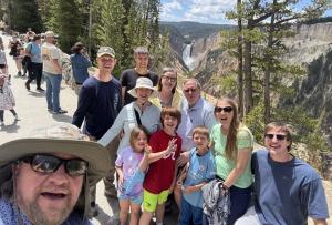Multigenerational family with Teton Excursions owner Aaron Bailey at the Lower Falls of the Grand Canyon of the Yellowstone on a private guided tour.