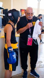 Howard Mena owner of MBC Mena's Boxing Club in Houston Texas offering one of his fighters advice and direction before his bout.