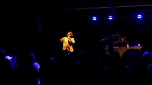 Ashwin Gane performing on stage with DJ behind him at Lowbrow Palace El Paso concert.