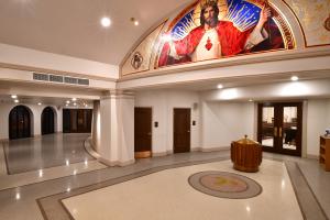 church entry with holy water fountain and brass Tau cross embedded
