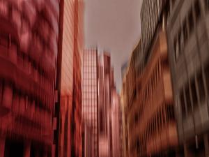 Abstract urban ICM photograph in red, orange and dark tones with blurred city motion and textured architectural rhythm.