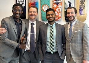 Four NX Direct team members standing together, representing the company’s focus on mentorship and career advancement.