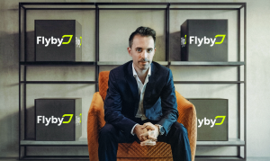 Tomaso Rodriguez, Chairman of Flyby and former CEO of Talabat seated surrounded by Flyby boxes