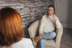 patient and therapist during addiction treatment counseling session in a clinical environment
