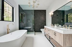 Luxurious bathroom remodel by Grand Building Construction featuring custom vanity, walk-in shower, and premium tile finishes in Renton WA