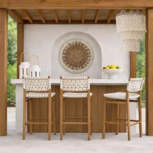 Woven bar stools with teak frames under outdoor pergola bar