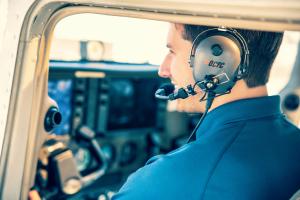 Student pilot flying a training aircraft during a lesson with Orange County Flight Center at John Wayne Airport under a Part 141 training program.