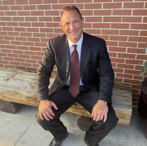 Eric Kaasa sitting in black suit