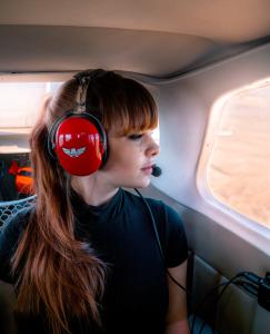 Passenger observing the landscape during a fixed-wing scenic flight over Sedona.