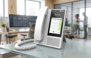 E-MetroTel Infinity 7005D digital smart desk phone on a modern office desk, featuring a touchscreen interface and handset, designed for enterprise communications