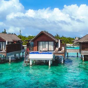 Overwater villa with private pool at Grand Park Kodhipparu Maldives, set above a turquoise lagoon just 20 minutes from Malé.