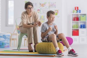 photo child sitting on a large bean bag chair very frustrated with mother sitting beside him looking upset