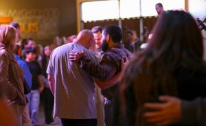 Two men embracing during fellowship at Calvary Chapel The Rock church service in Santa Rosa Sonoma County California