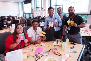 Volunteers from Allina Health, a partner of Friends & Co, hold handmade cards created for older adults in Minnesota through the Cards Connect program.