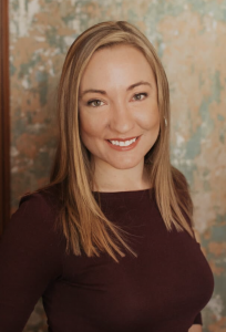 Erica Johnson, Licensed Marriage and Family Therapist and founder of Affinity Counseling of Colorado, smiles warmly in a professional headshot against a softly textured background.