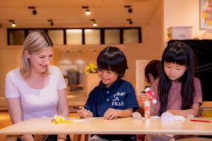 Foreign teacher playing with Japanese school children at Awaji Island International School