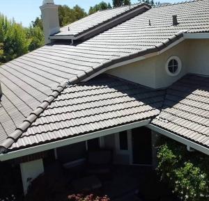 Multi-level residential home featuring a newly installed, modern grey tile roof with clean lines and expert flashing work in the Greater Sacramento area.