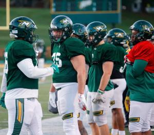 McDaniel College student-athlete Tom Green, 60, lines up with teammates decades younger during spring practice as he prepares for the 2026 Green Terror football season.