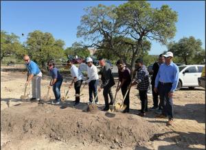 TX Sparks team members and Lago Vista city officials participate in a groundbreaking ceremony at a development site.