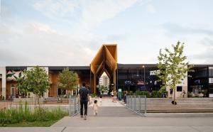 A photograph of M-K-T Heights entrance with people walking around.