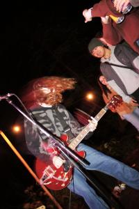 bass and guitar players in action on stage