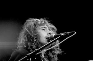 young man with long curly hair at mic