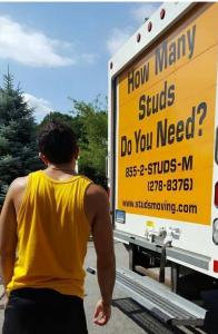 Mover in yellow shirt getting ready to load moving truck