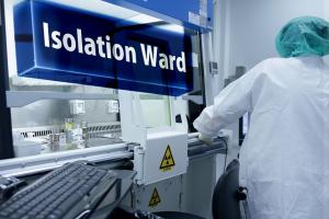 Nurse in a clinic facing away from the camera, symbolizing patient-focused healthcare and local clinic marketing.