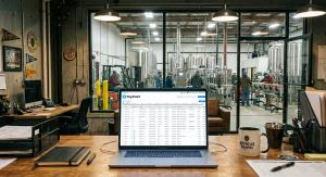 A laptop in the back office of a brewery with PaySmart on the screen.