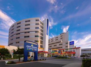 Evening exterior of Johns Hopkins All Children’s Hospital in St. Petersburg, Florida, illuminated against the dark sky.