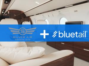 An interior of a private charter jet with Silver Air Private Jets and Bluetail logos