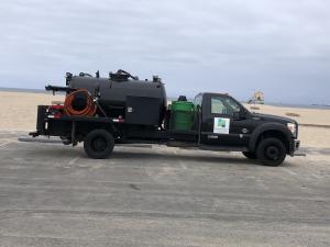 Grease trap cleaning service truck parked at a restaurant location in Orange County