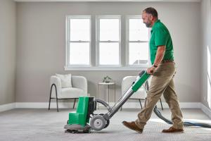 Professional carpet cleaning technician using equipment for deep carpet cleaning in Calgary, Okotoks and Cochrane homes.