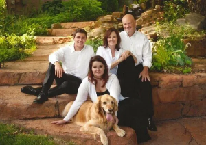 Jim Stapleton, owner of the Omaha sign company First Impression Signs and Graphics, sitting with his family and dog.