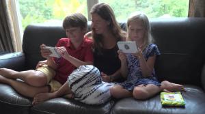 Connection Zoo cards can be used as conversation cards or played as a game. Shown here, a mom and two kids enjoy connecting with Connection Zoo animal cards. 