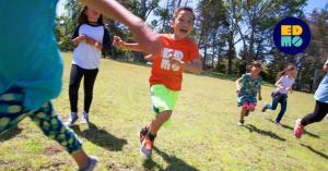 A group of kids running and playing together at EDMO Summer Camp